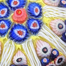 Vintage Strathearn Glass Art Paperweight Colorful Paneled Millefiori and White Filigree on Opaque Yellow Ground