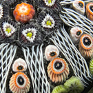 Vintage Strathearn Glass Art Paperweight Colorful Paneled Millefiori and White Filigree on Opaque Black Ground
